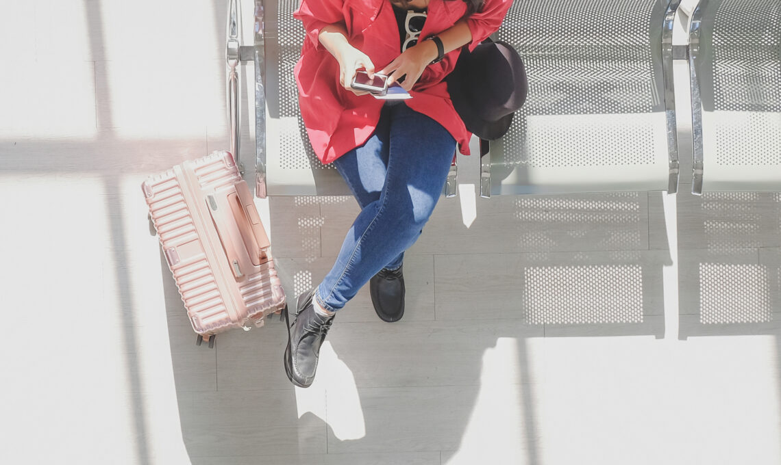 Woman at airport using phone