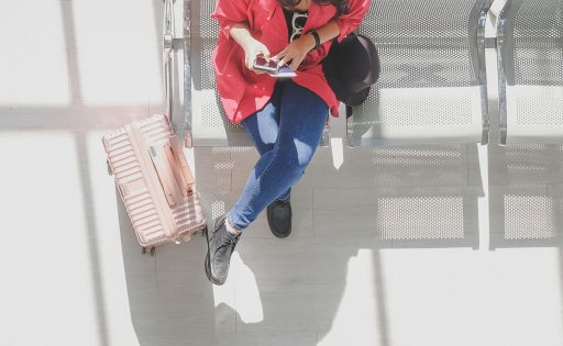 Woman at airport using phone