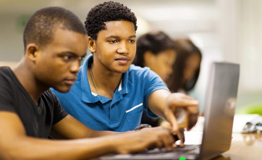 Young African men using laptop to learn online